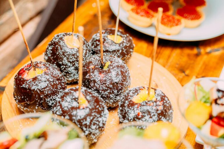 Tasty chocolate dessert on wooden stick on table